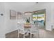 Bright dining area featuring a wooden table set, modern lighting fixture, and a sliding door to the pool at 5941 S Cambridge St, Chandler, AZ 85249