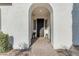 Inviting front entrance with arched doorway, lantern accents, and lush greenery, creating a warm welcome at 5941 S Cambridge St, Chandler, AZ 85249