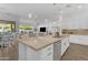 Kitchen island with bar seating has stainless steel dishwasher and leads to living space at 5941 S Cambridge St, Chandler, AZ 85249