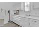 Bright laundry room with white cabinetry and a practical sink, offering both style and functionality at 5941 S Cambridge St, Chandler, AZ 85249