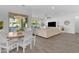 Open layout has a table and seating, living space with sofa, and access to the pool and patio at 5941 S Cambridge St, Chandler, AZ 85249