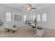 Bright home office with large windows, modern desk, ceiling fan, and comfortable seating at 5941 S Cambridge St, Chandler, AZ 85249