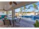Outdoor patio featuring a dining area with a view of the pool and landscaped backyard at 5941 S Cambridge St, Chandler, AZ 85249