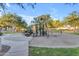Neighborhood playground with slides and climbing area surrounded by trees and lush green grass at 5941 S Cambridge St, Chandler, AZ 85249