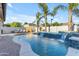 Backyard pool with integrated water features, palm trees, and lounge chairs for sunbathing at 5941 S Cambridge St, Chandler, AZ 85249