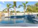 Sparkling backyard pool with palm trees and water features, offering a tranquil and tropical outdoor space at 5941 S Cambridge St, Chandler, AZ 85249
