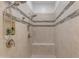 Modern walk-in shower featuring neutral tile, a shower seat, and dual shower heads at 5941 S Cambridge St, Chandler, AZ 85249