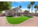 Large backyard featuring lush artificial turf and mature palm trees, perfect for outdoor enjoyment at 641 W Oriole Way, Chandler, AZ 85286