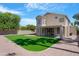 Expansive backyard with artificial turf, a covered patio, and desert landscaping on a sunny day at 641 W Oriole Way, Chandler, AZ 85286