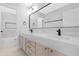 Bright bathroom with double sinks, quartz countertop, black fixtures and marble floor at 641 W Oriole Way, Chandler, AZ 85286