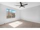 Bedroom featuring a ceiling fan, neutral carpet, and a bright window overlooking neighborhood at 641 W Oriole Way, Chandler, AZ 85286