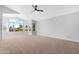 Large bedroom featuring soft neutral carpet, great natural light, and a ceiling fan at 641 W Oriole Way, Chandler, AZ 85286