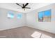 The bedroom is bright with carpet, neutral walls and ample sunlight through two windows at 641 W Oriole Way, Chandler, AZ 85286