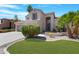 An attractive home featuring a well-manicured lawn, desert plants, and a charming front entrance at 641 W Oriole Way, Chandler, AZ 85286