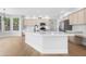 Modern kitchen featuring a large center island with marble countertops, stainless steel appliances, and light wood floors at 641 W Oriole Way, Chandler, AZ 85286