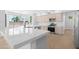 Elegant kitchen featuring a quartz island, stainless steel appliances, light cabinetry, and ample natural light from large windows at 641 W Oriole Way, Chandler, AZ 85286