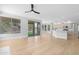 Open-concept living space with light wood floors, backyard access, and a modern kitchen with an island at 641 W Oriole Way, Chandler, AZ 85286