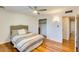 Comfortable bedroom features wood floors, a ceiling fan, closet, and bright natural light at 803 W 18Th St, Tempe, AZ 85281