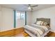 Inviting bedroom with wood floors, a ceiling fan, and large window offering scenic views at 803 W 18Th St, Tempe, AZ 85281