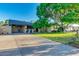 Inviting single-story home featuring manicured lawn, mature shade tree and long private driveway at 803 W 18Th St, Tempe, AZ 85281