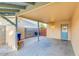 Covered patio featuring block wall, storage, concrete flooring, and access door to the property at 803 W 18Th St, Tempe, AZ 85281