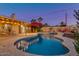 Lush backyard oasis featuring a sparkling pool, mature landscaping, and covered patio with seating area at 803 W 18Th St, Tempe, AZ 85281