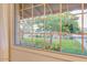 Window view showcases landscaped front yard with mature trees and blooming flowers at 803 W 18Th St, Tempe, AZ 85281