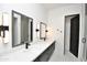 Bathroom with dual sinks, quartz countertops, modern lighting, and a glass-enclosed shower at 8934 E Rusty Spur Pl, Scottsdale, AZ 85255