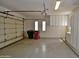 Clean, spacious garage featuring built-in storage cabinets, ample lighting, and a two-car capacity at 8934 E Rusty Spur Pl, Scottsdale, AZ 85255