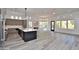 Open concept kitchen with quartz countertops and black accents open to the living room and dining room at 8934 E Rusty Spur Pl, Scottsdale, AZ 85255