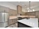 Modern kitchen featuring quartz countertops, stainless steel appliances, and custom wood cabinetry at 8934 E Rusty Spur Pl, Scottsdale, AZ 85255