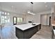 Open concept kitchen with quartz countertops and black accents open to the great room at 8934 E Rusty Spur Pl, Scottsdale, AZ 85255
