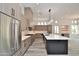 Open kitchen with stainless steel appliances, large island, and seamlessly flows to dining area at 8934 E Rusty Spur Pl, Scottsdale, AZ 85255
