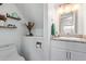 Stylish half bathroom with modern vanity, granite countertop, and decorative shelves at 9047 N 52Nd Ave, Glendale, AZ 85302
