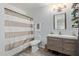 Fresh bathroom design with modern vanity, stylish shower curtain, and ample lighting at 9047 N 52Nd Ave, Glendale, AZ 85302