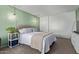 This bright bedroom features a bed with decorative pillows, modern lighting, and an entertainment unit at 9047 N 52Nd Ave, Glendale, AZ 85302