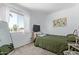 Bright bedroom with a large window, soft carpet, and calming paint, perfect for rest at 9047 N 52Nd Ave, Glendale, AZ 85302