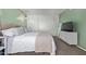This bedroom features green walls, a queen-sized bed, and a white dresser with a TV at 9047 N 52Nd Ave, Glendale, AZ 85302