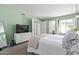 Inviting bedroom with dresser, TV, large window, and a comfortable, cozy bed at 9047 N 52Nd Ave, Glendale, AZ 85302