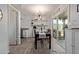 Open-concept dining room featuring modern light fixture and access to outdoor patio at 9047 N 52Nd Ave, Glendale, AZ 85302