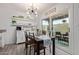 Bright dining room with modern chandelier, adjacent to the kitchen and outdoor patio at 9047 N 52Nd Ave, Glendale, AZ 85302