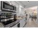 This kitchen features stainless steel appliances, stone counters, and tile floors at 9047 N 52Nd Ave, Glendale, AZ 85302