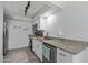 Modern kitchen features stainless appliances, stone counters, and white cabinetry at 9047 N 52Nd Ave, Glendale, AZ 85302