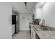 This kitchen boasts stainless steel appliances, granite counters, and white cabinets at 9047 N 52Nd Ave, Glendale, AZ 85302
