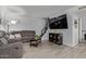 Inviting living room featuring a sectional sofa, mounted TV, and staircase at 9047 N 52Nd Ave, Glendale, AZ 85302