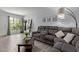 Comfortable living room with a gray sectional, decorative artwork, and a bright window at 9047 N 52Nd Ave, Glendale, AZ 85302