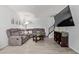 Cozy living room featuring a plush gray sectional, modern flooring, and sleek entertainment center at 9047 N 52Nd Ave, Glendale, AZ 85302