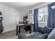 Functional office space with desk, shelving, and a comfortable sofa for versatile use at 9047 N 52Nd Ave, Glendale, AZ 85302