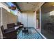 Comfortable outdoor patio seating with charming string lights and bright patterned outdoor rug at 9047 N 52Nd Ave, Glendale, AZ 85302