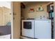 Convenient utility room with washer, dryer, and storage shelving for laundry needs at 9047 N 52Nd Ave, Glendale, AZ 85302